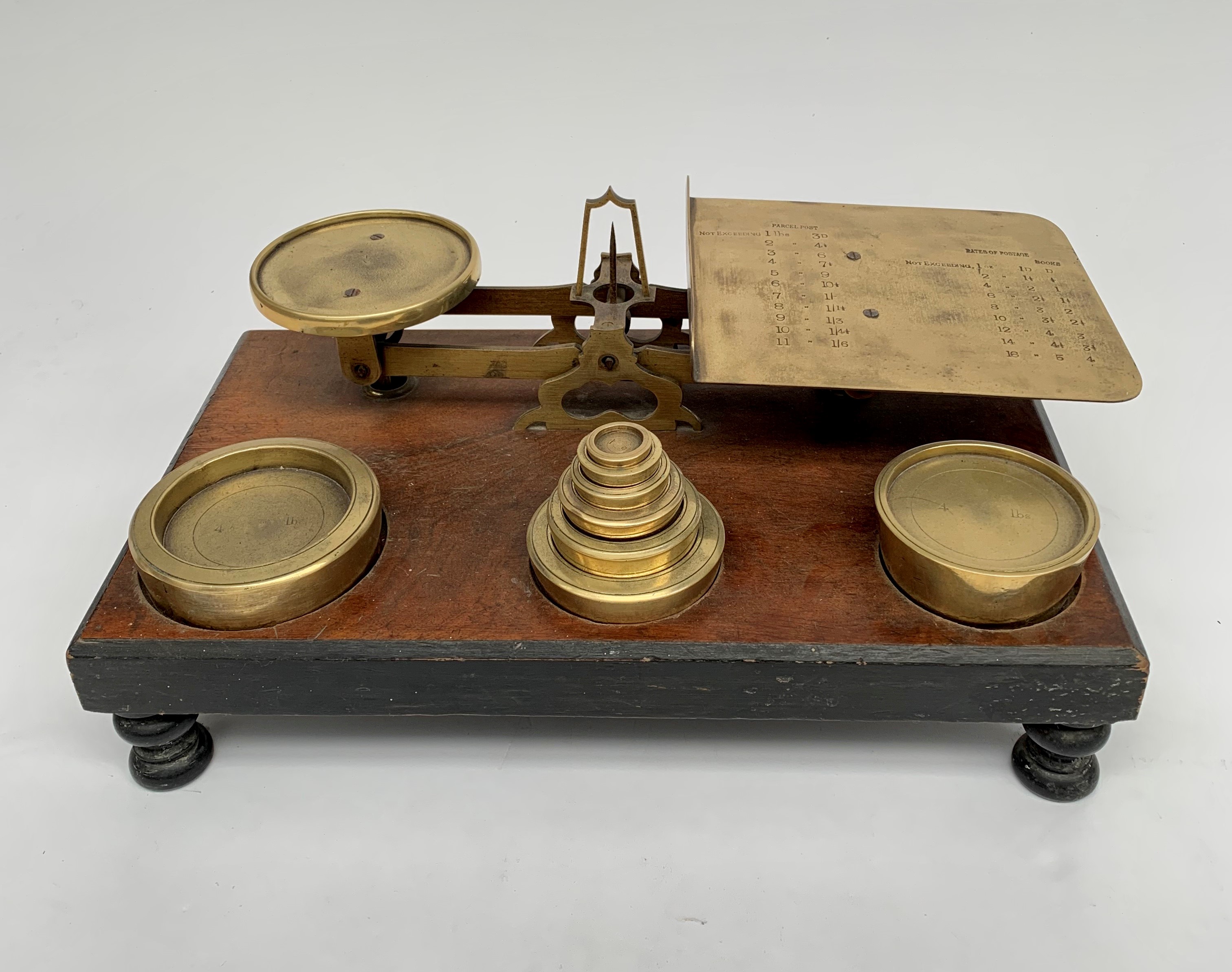 A pair of large Victorian walnut and brass parcel scales, the pan with etched postage rates,