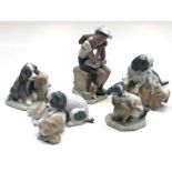 A Lladro figure of a schoolboy, seated with a dog at his feet, height 21cm,