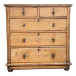 An Arts and Crafts pine chest of drawers, with two short and three long graduated drawers,