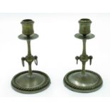 A pair of brass candlesticks, the knopped stems with ring drops,