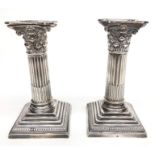 A pair of filled silver Corinthian column candlesticks by William Hutton & Sons Ltd, London 1910,