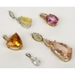 An opal and diamond white gold pendant and four other stone set gold pendants.