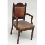 An Edwardian mahogany child's chair, with a padded back and seat on turned tapering legs,