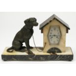 A French Art Deco marble mantel clock, modelled as a bronzed spelter dog beside a kennel,