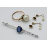 An Art Deco white gold bar brooch, set a blue stone, together with a gold ring,