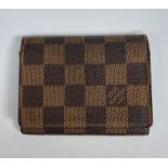 A Louis Vuitton chequer purse, leather lined interior and branded fabric storage bag, height 8.