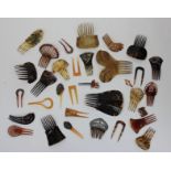 A collection of hair ornaments and mantilla combs mostly tortoiseshell, approximately 30.