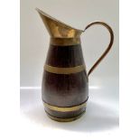 An oak brass bound large jug, of coopered construction, with loop handle, height 54cm.
