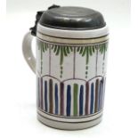 A polychrome painted tin glazed mug, early 19th century,