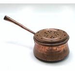 A Victorian copper pan, with a hinged pierced cover, height 11cm, length 38.5cm.