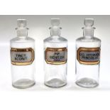 Three apocathary glass jars, each with a glass stopper, height 18cm.