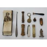 A vegetable ivory needle case, a nut fob set with a Stanhope lens, a Victorian pocket book,