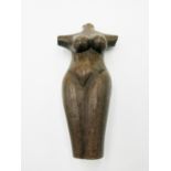 A carved stone sculpture of a female torso, with indistinct inscription, length 32cm.