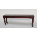 A Victorian mahogany window seat, the rectangular moulded top on turned tapering legs, height 47cm,