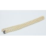 A string of 113 cultured pearls each of 7.3mm, gold clasp.