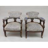 A pair of Edwardian mahogany upholstered tub armchairs, height 78cm, width 64.5cm.