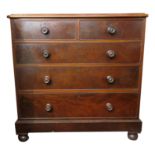 A Victorian mahogany chest of drawers, with two short and three long graduated drawers on bun feet,