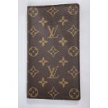 A Louis Vuitton monogram wallet, leather lined interior and branded fabric storage bag, height 10.