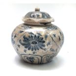 A Chinese blue and white jar and cover, decorated with flowerheads and vines, height 12cm.