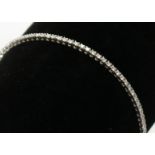 An 18ct white gold tennis bracelet with a line of diamonds. Condition report: Approx.