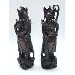 A pair of Chinese carved wood figures, late 19th century, each with silver wire inlay, height 42cm.