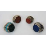 A group of four massive silver stone inlaid signet rings each with a stone intaglio.