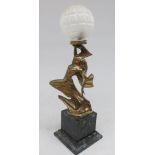 An Art Deco style cast metal table lamp with a leaping maiden holding aloft an etched glass