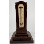 A red serpentine desk thermometer of generous proportions late 19th century, of moulded column form,