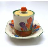 A Clarice Cliff crocus pattern preserve pot and cover, height 8cm, and a dish.