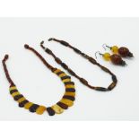 A pair of simulated amber earrings and two simulated amber necklaces.