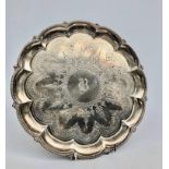 An engraved Victorian silver salver on three feet with scalloped rim and beaded border by Barnard &