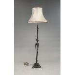 An 18th century style metal standard lamp, with silk shade, height 178cm.