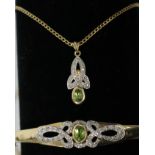 A 9ct gold hinged bangle set with peridot flanked by ribbons of pave set diamonds together with a
