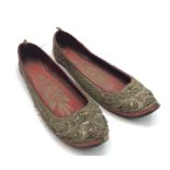 A pair of Islamic slippers, each with foliate decorated metal thread, length 24cm.