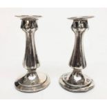 A pair of Art Nouveau filled silver candlesticks by C B Thomas & Co, Birmingham 1911, height 13.5cm.
