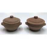 A pair of Leach twin handled bowls and covers, with glazed interiors, height 9cm, width 15cm.