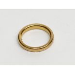 A very high purity gold band, tests as 22ct, 5.3g.
