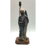 A ;large Chinese pottery figural lamp, on a leather covered plinth, height 74.5cm .