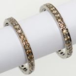 A pair of platinum or white gold eternity rings each set with yellow diamonds, Wartski box.