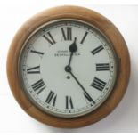 An oak circular wall clock, the white painted dial signed Cross & Co, Bexhill on Sea,