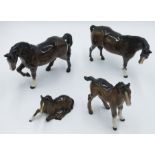 A Beswick figure of a standing horse, height 15cm, another Beswick horse and two foals.