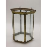 A brass hexagonal hanging lantern, early 20th century, with six glazed rectangular panels,