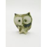 A Carn Pottery figure of an owl, in typical brown green colours, height 7cm.