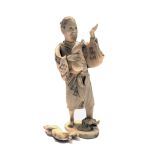 A Japanese ivory okimono, Meiji period, the man holding a double gourd, a tree stump at his feet,