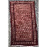 A Belouch rug, the camel field with rows of diamond motifs enclosing serrated guls,