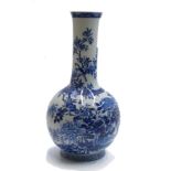 A Japanese blue and white porcelain bottle vase, the body with birds and a flowering tree,