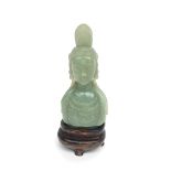 A jade bust on wooden stand, height 13cm, width 6cm.