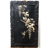 A pair of Japanese black lacquered wall plaques, circa 1900,