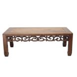 A Chinese hardwood Kang table, circa 1900, with a foliate carved frieze,