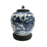 A Chinese blue and white porcelain ginger jar, late 18th century, with metal cover and wooden stand,